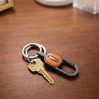 Stylish metal key holder clip attached to belt or backpack
