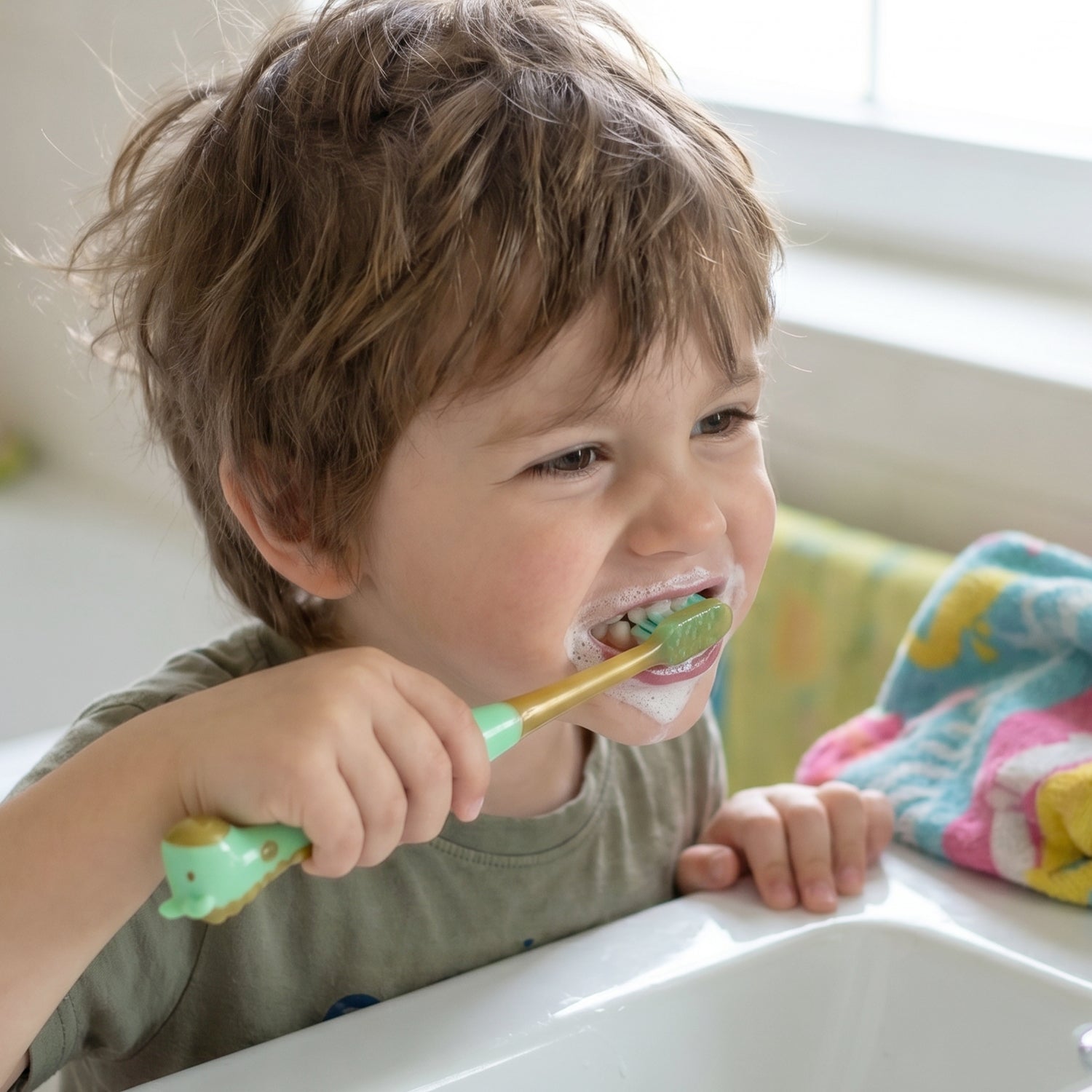 Manual kids toothbrush with attached toy whistle encouraging enjoyable brushing