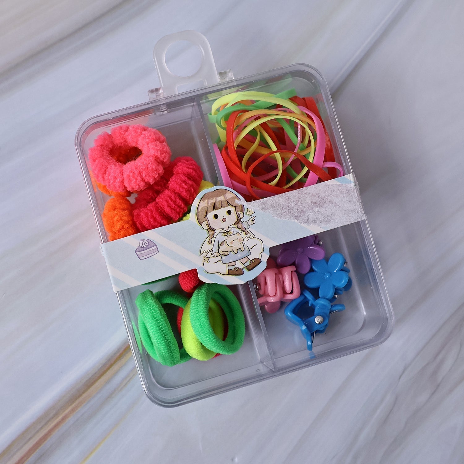 Child's hand selecting a vibrant hair clip from the organised kids hair accessories box.