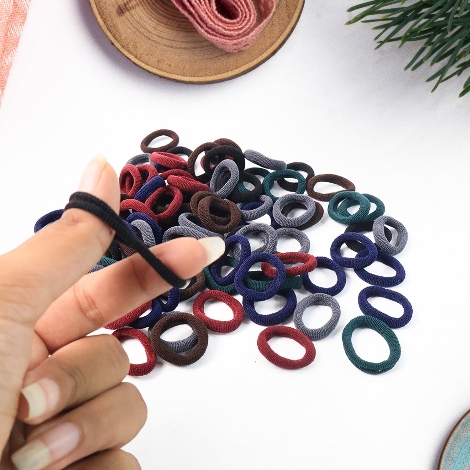 The full pack of 100 multicolour small hairbands, ready for versatile hair styling for girls.