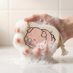Side view of a cartoon bath scrubber sponge with a secure hanging rope.