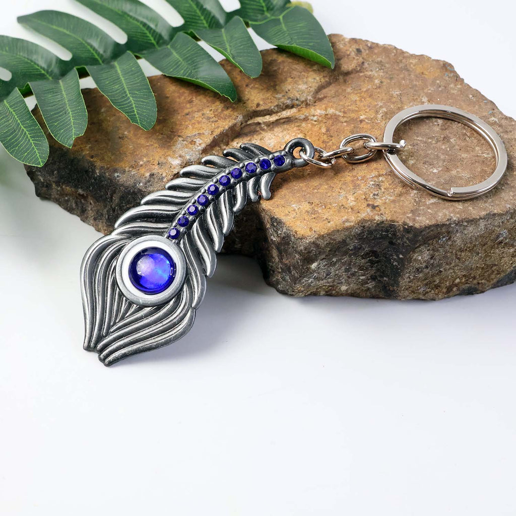 Close-up image showing peacock eye design on metal keychain