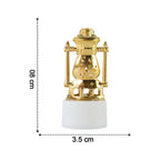 Hand holding a flameless LED tealight to illustrate its compact size.