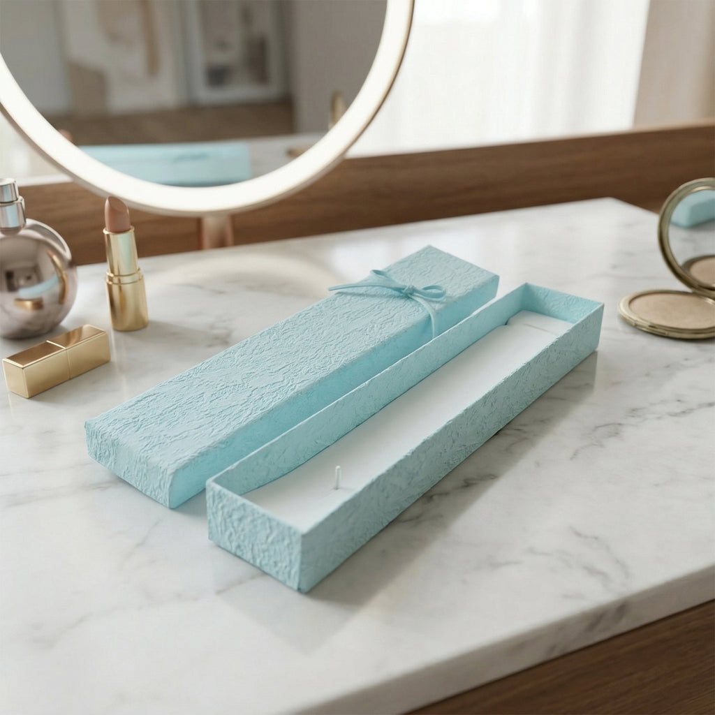 Long rectangular jewelry box with decorative ribbon closure and soft interior