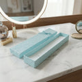 Long rectangular jewelry box with decorative ribbon closure and soft interior
