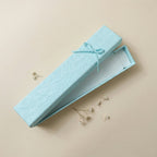 Close-up of textured box surface and ribbon detail