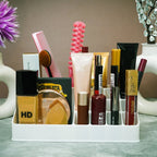 Clear makeup organiser filled with various lipsticks and beauty products.