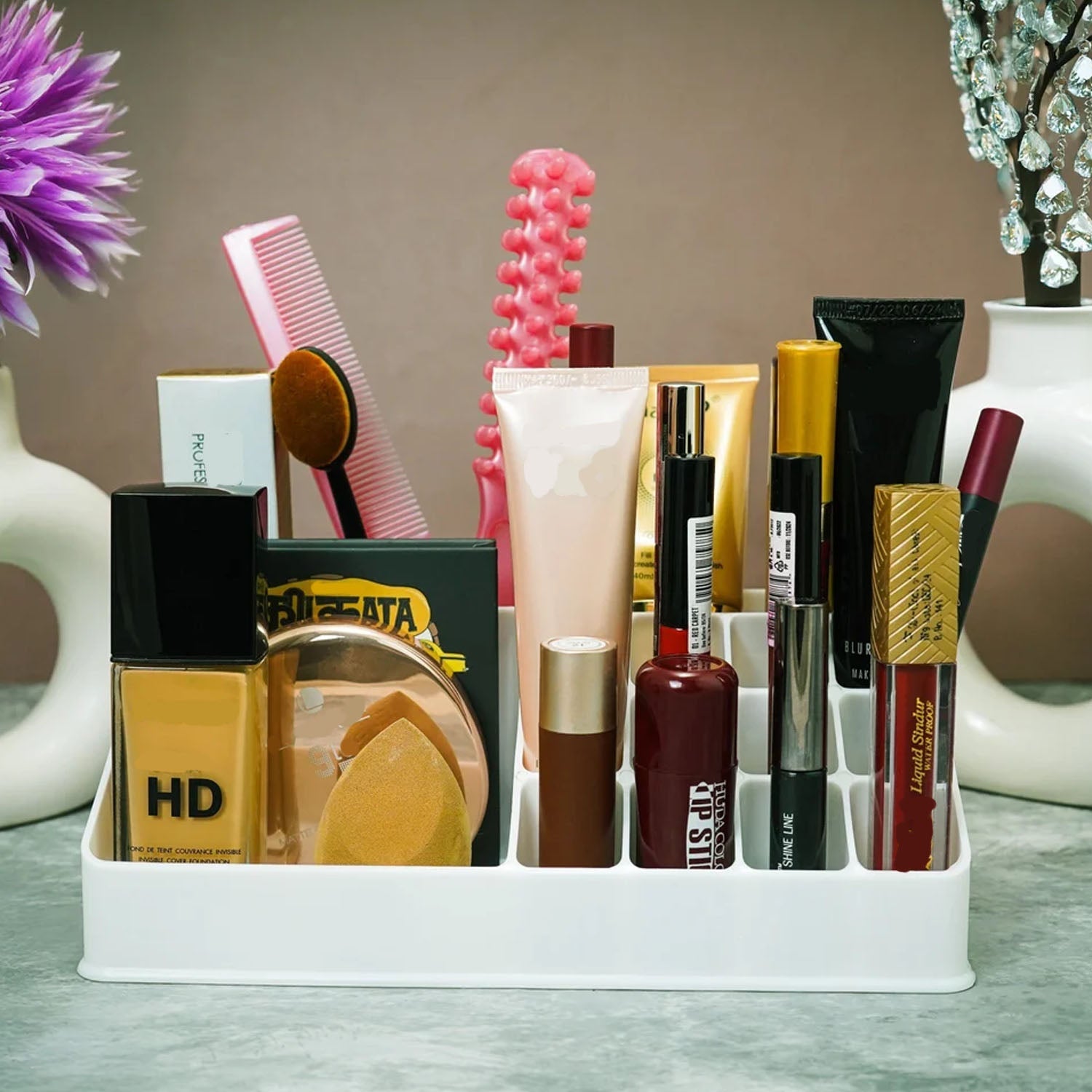 Clear makeup organiser filled with various lipsticks and beauty products.