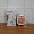 Mini air cooler fan in use on desk with mist spray on