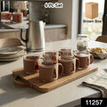 Set of six elegant ceramic tea cups with handles, arranged neatly for serving