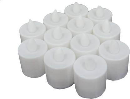 Several LED tealight candles illuminating a dark setting, showing their warm glow.