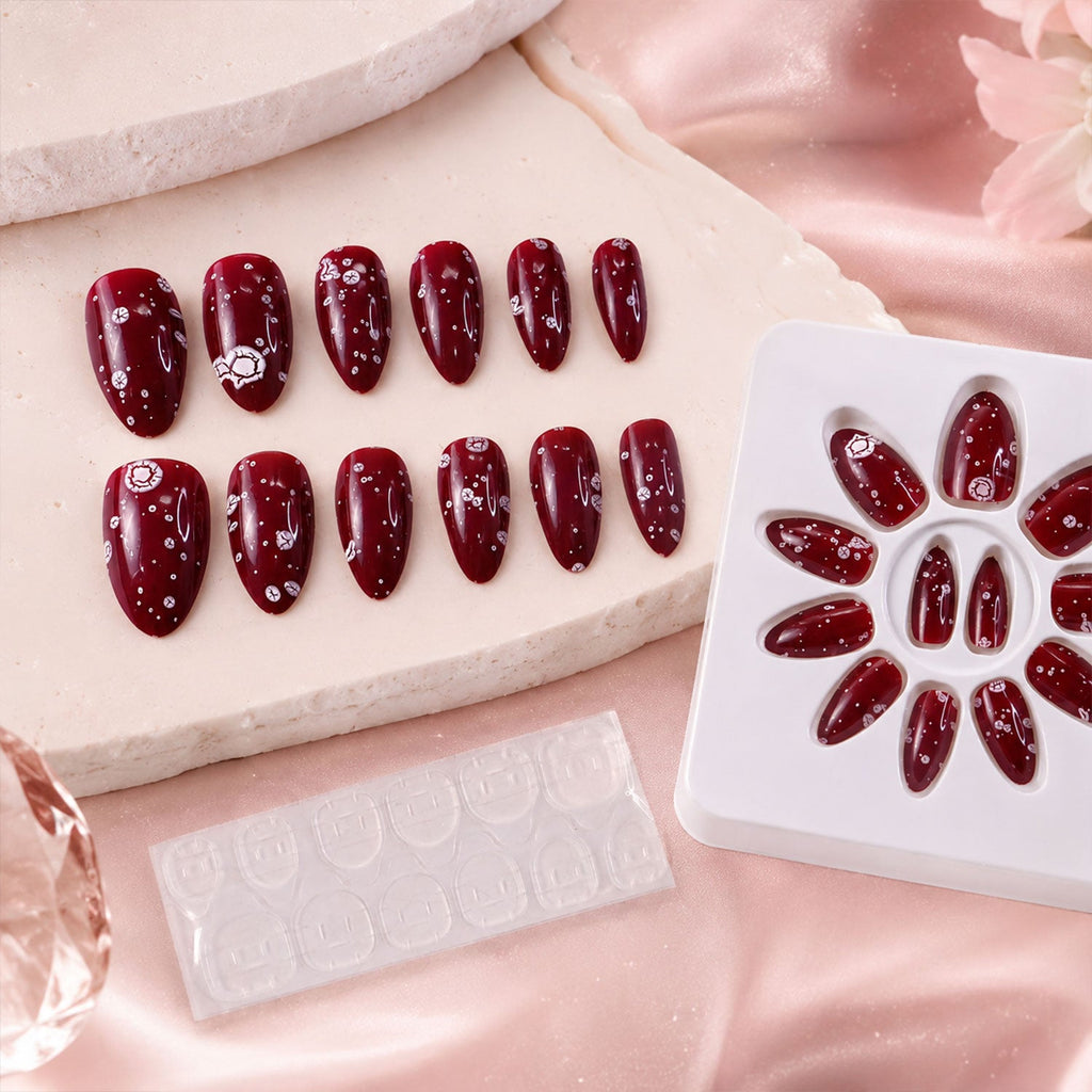 Close-up of a glossy long coffin press-on nail featuring intricate 3D decor
