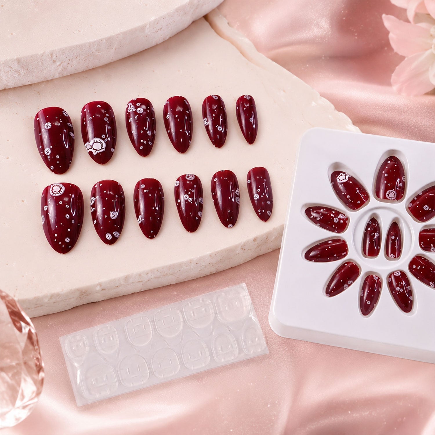 Close-up of a glossy long coffin press-on nail featuring intricate 3D decor