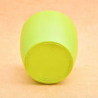 Green round plastic planter with a plant, showcasing its sturdy design for gardening.