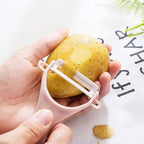 Hand holding the anti-slip handle of the Y-shaped fruit and vegetable peeler.