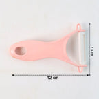 Stainless steel peeler removing skin from a potato, showcasing its swivel blade.