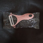 Detailed view of the durable stainless steel blade of the kitchen peeler.