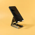 Metal mobile phone stand holder showing angled view with phone