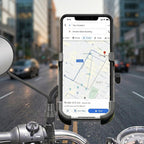 Smartphone securely held in the metal bike phone holder, attached to a rear view mirror on a bike.