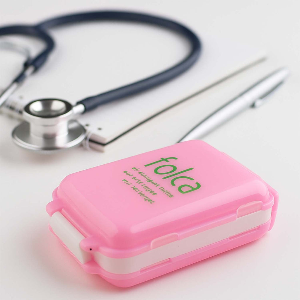 Pink pill box featuring secure snap locks on each side