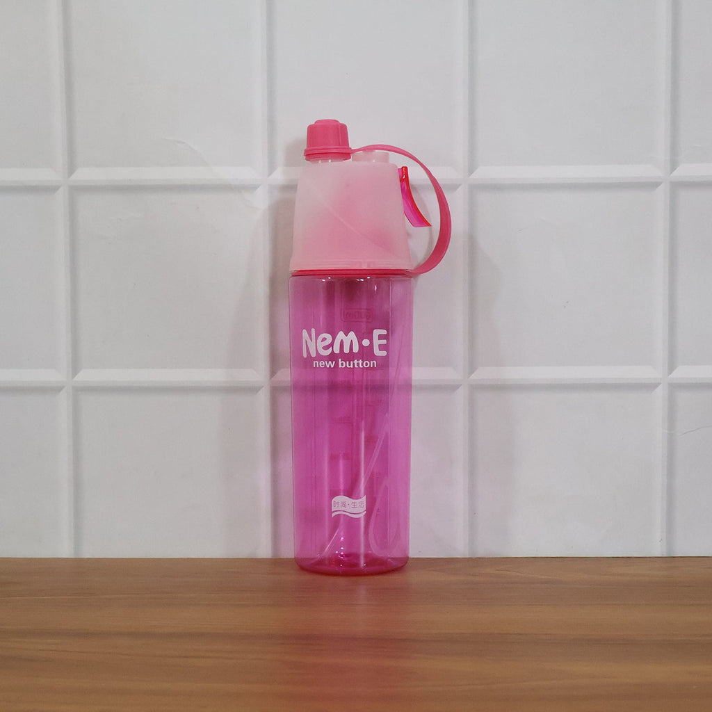 In use: pink sports water bottle with mist spray feature active