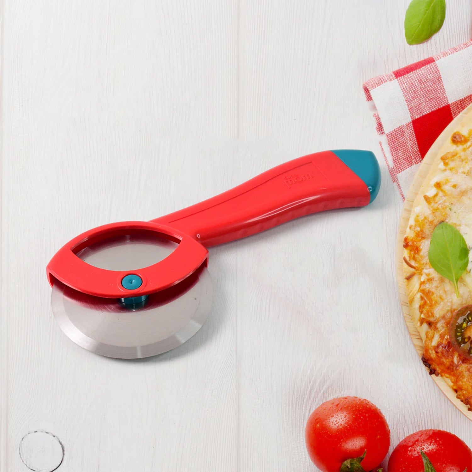 Pizza cutter slicing fresh pizza with sharp stainless steel rotary blade.