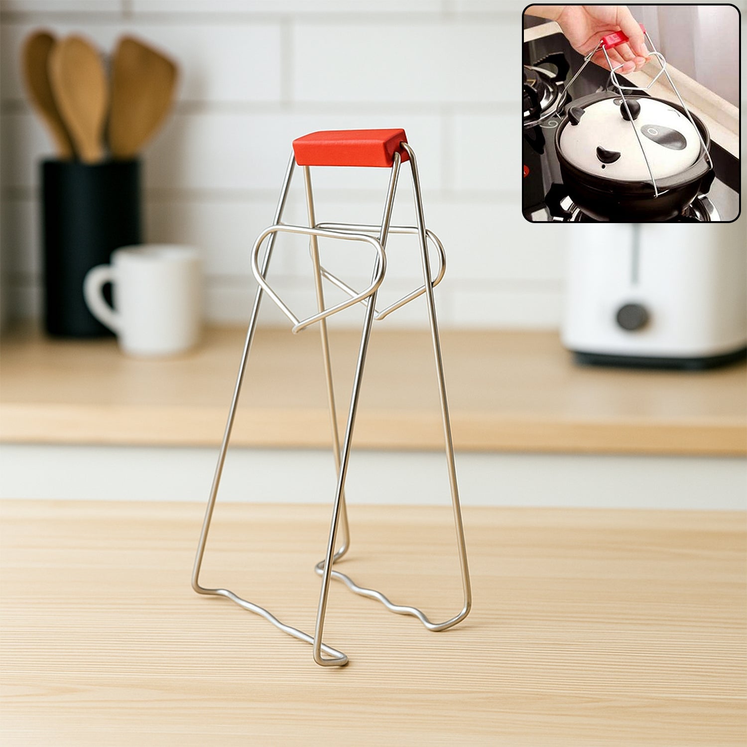 Stainless steel vessel gripper tong securely gripping a hot kitchen dish