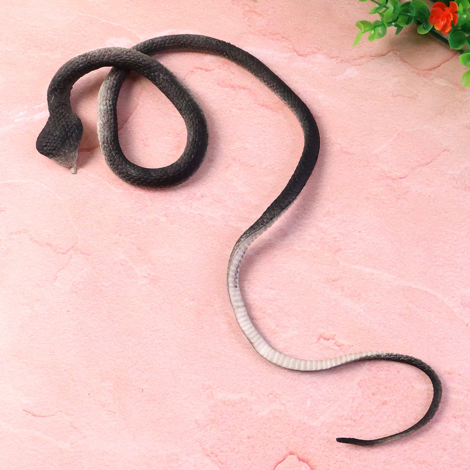 Lifelike dummy snake toy used for pranks and imaginative play