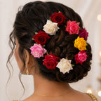 A collection of colourful flower hair pins in mixed hues, laid out for display.