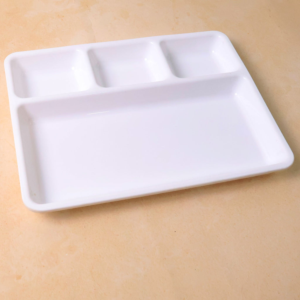 Empty 4-section plastic tray ready for meal preparation or serving.