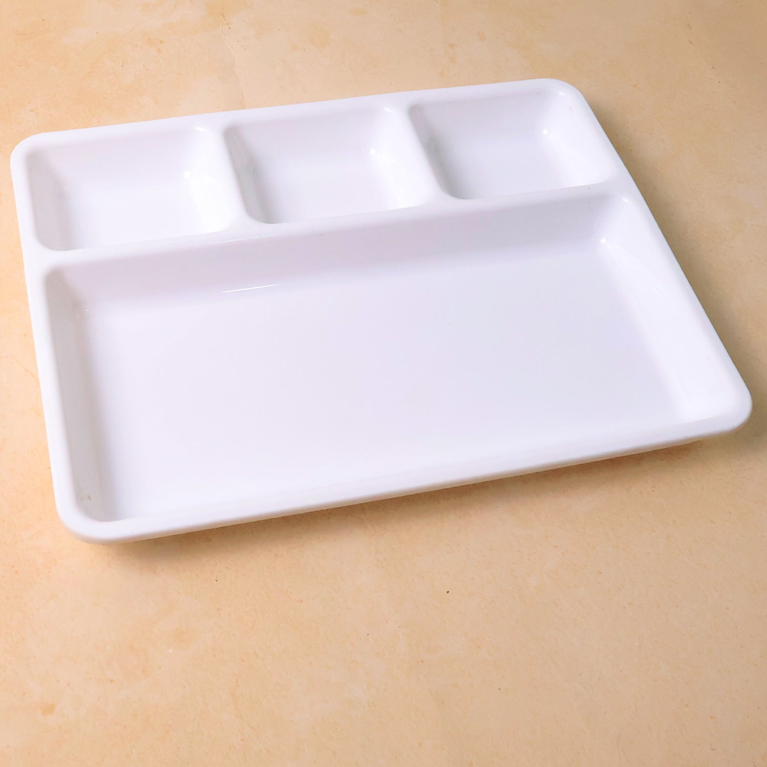 Empty 4-section plastic tray ready for meal preparation or serving.