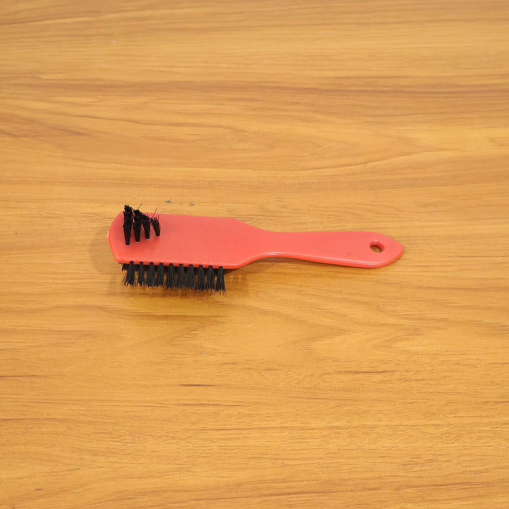 Shoe cleaning brush in use cleaning sneakers to remove dirt and stains