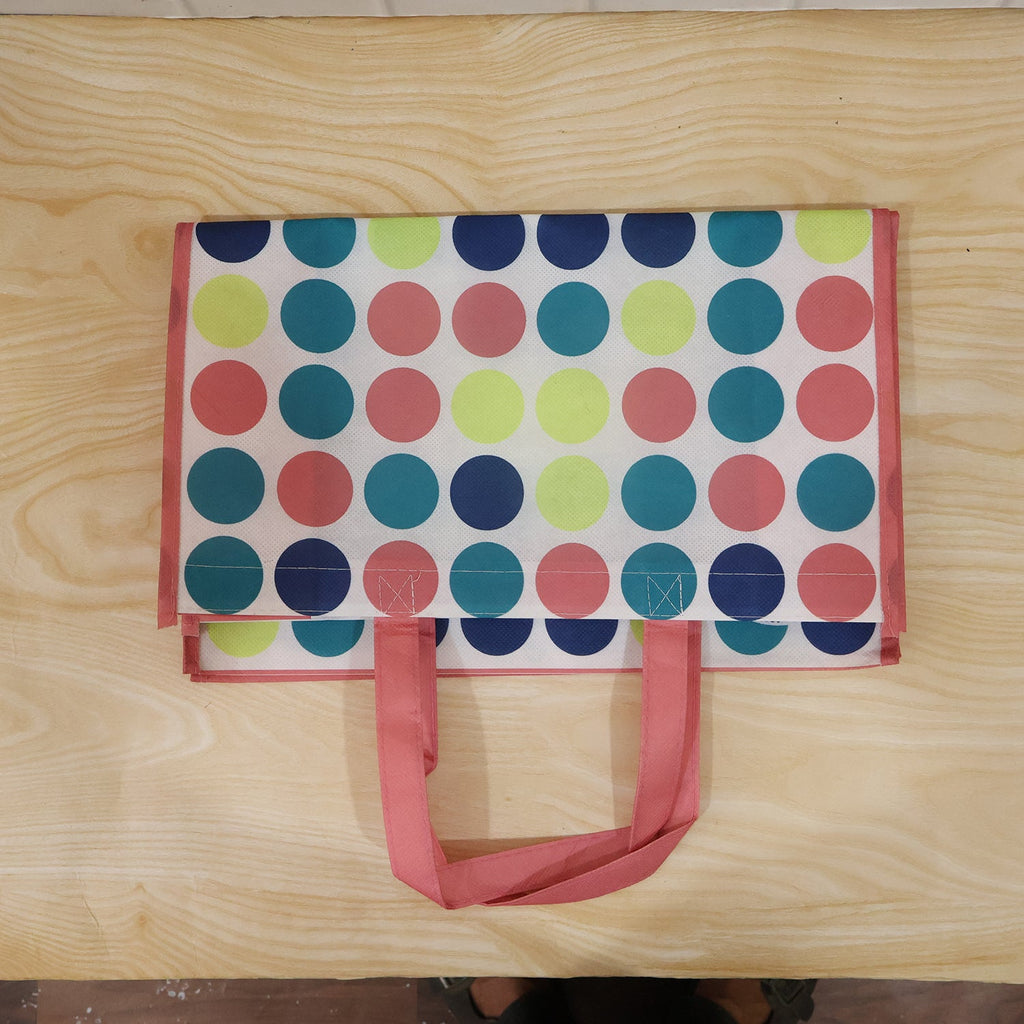 Person carrying large printed reusable shopping bag