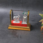 Close-up of Kamdhenu cow and Tulsi plant idol showing intricate silver plating