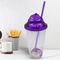 Vibrant plastic cold drink tumbler with lid and reusable straw, showcasing mixed colors.