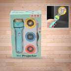 A child's hand holds the Mini Slide Projector for Kids, projecting a colourful animated pattern onto a wall.