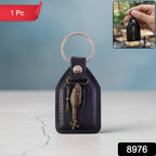 Close-up of metal sword emblem on leather finish keychain