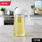 Close-up of glass oil bottle dispenser tilted to pour oil smoothly
