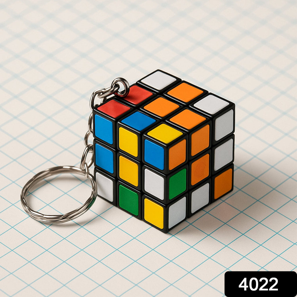 Hand holding a compact Mini Magic Cube Puzzle keychain, ready for play.