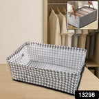 Stylish fabric storage bin placed on a wooden shelf, perfect for organizing clothes or linens.