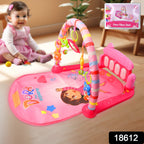 Infant kicking the musical piano on the Aditi baby play gym mat.