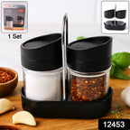 Two clear plastic spice jars on rotating black stand