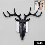 Decorative deer head wall hook holding keys and a small bag in a modern home.