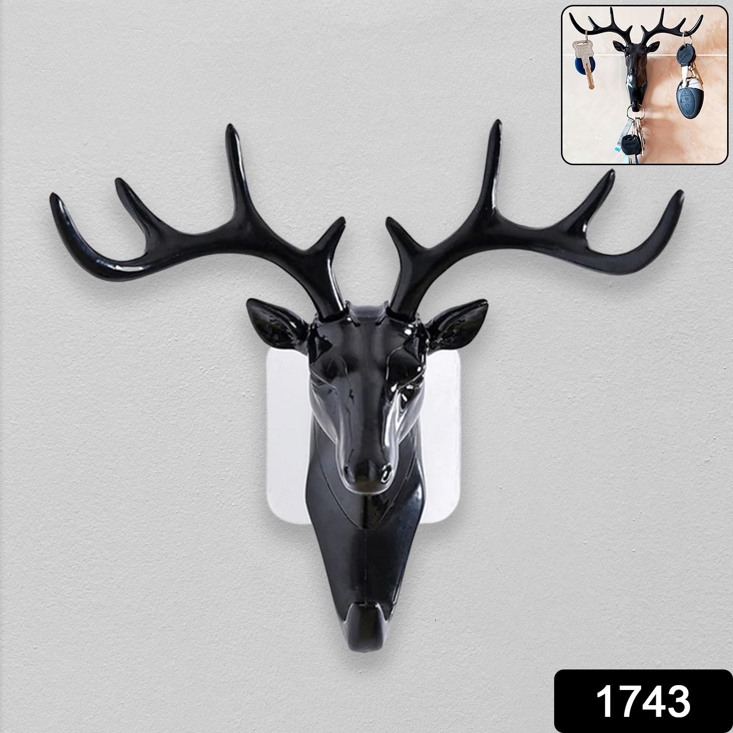 Decorative deer head wall hook holding keys and a small bag in a modern home.