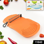 Cut 'n' Wash cutting board showing detachable knife and water draining through integrated strainer