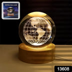 Close-up of the illuminated 3D crystal ball lamp showing intricate world map details.