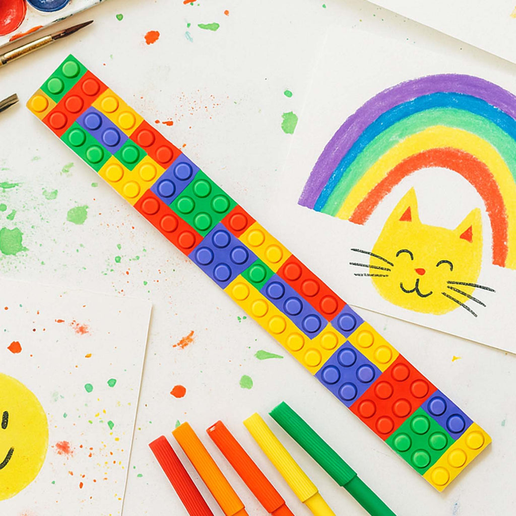 Multiple colorful snap slap bracelets arranged side by side