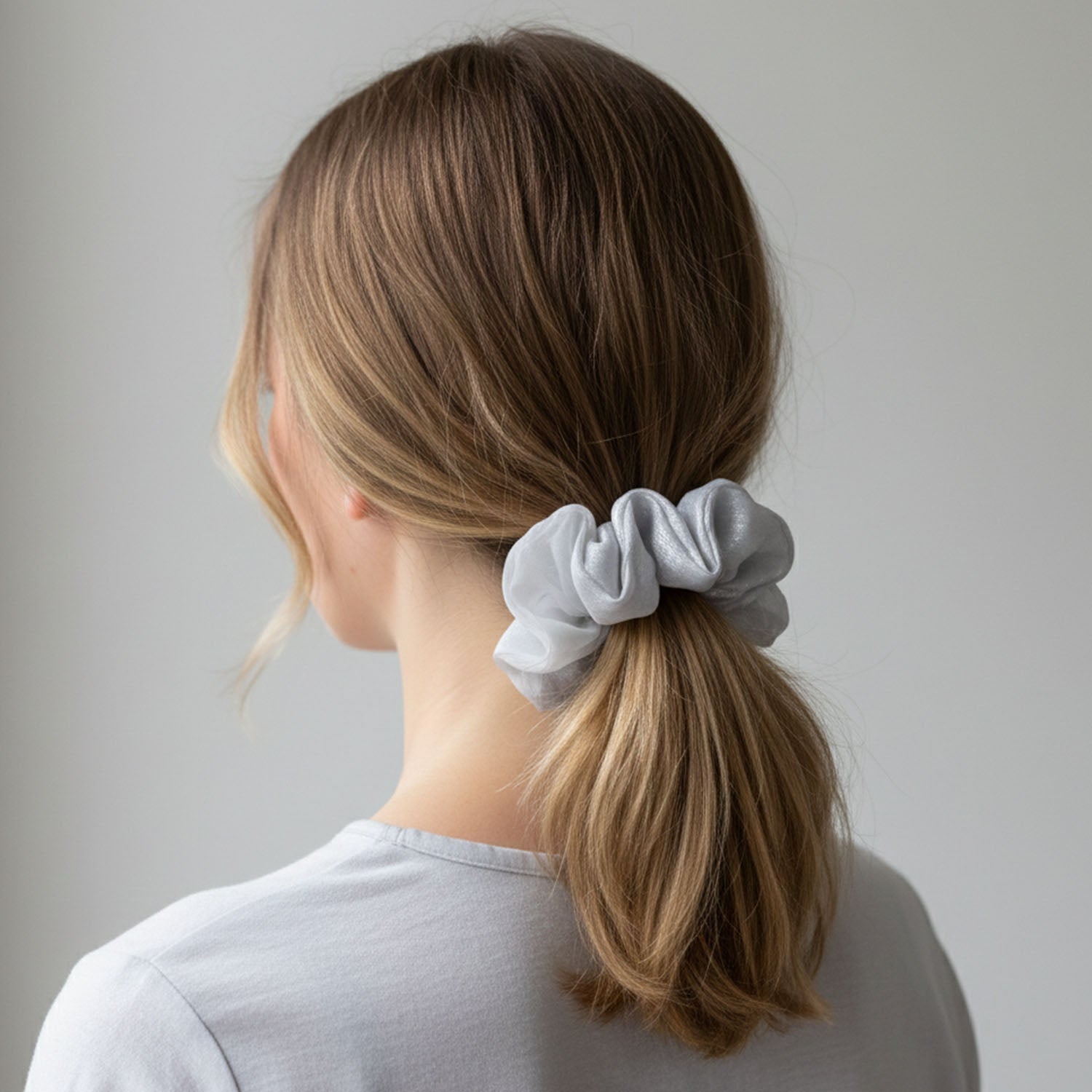 Close-up of hair tie made from dual-tone satin and mesh fabric
