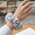 Detailed shot of satin mesh hair scrunchie material and construction