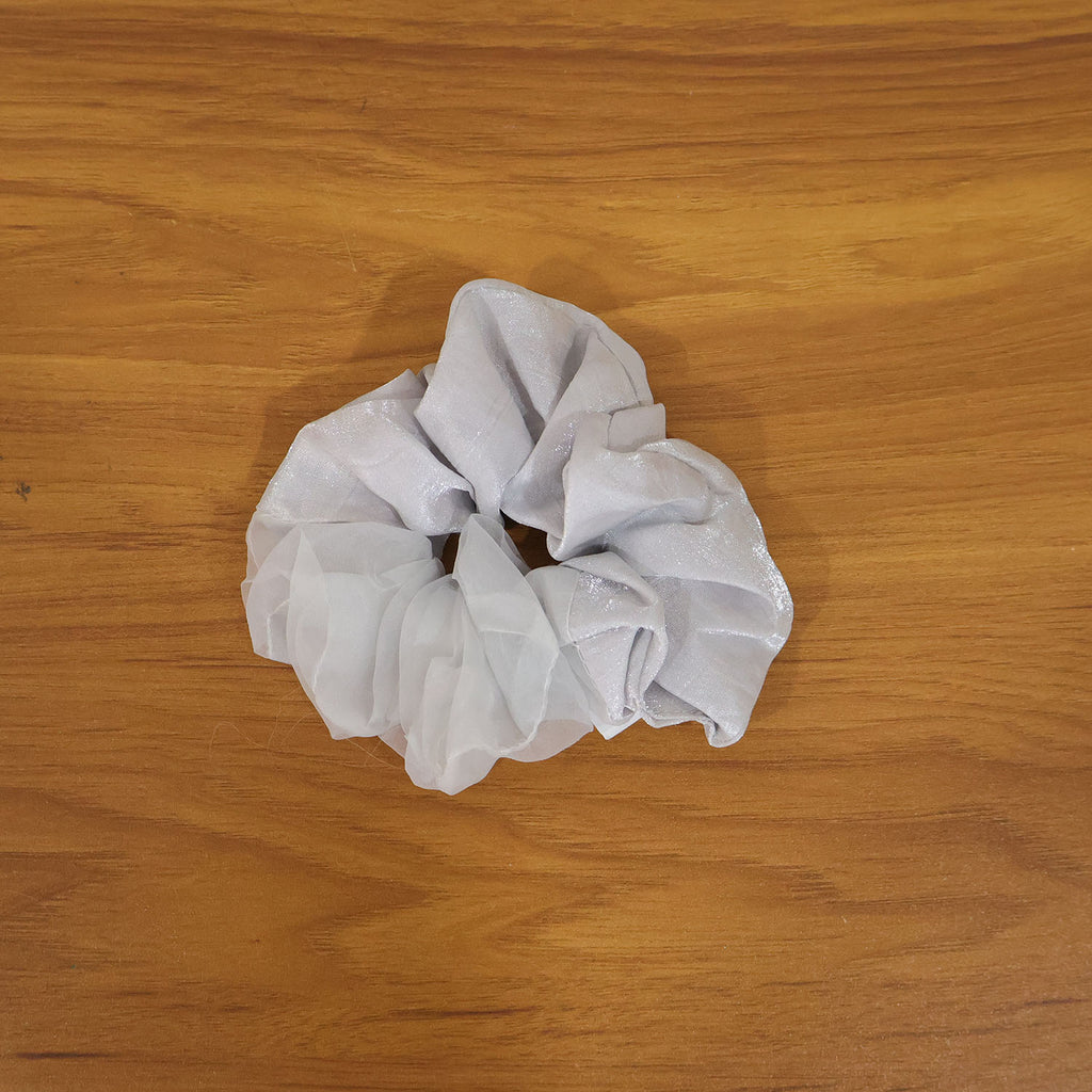 Model wearing elegant satin mesh hair scrunchie with a stylish hairstyle